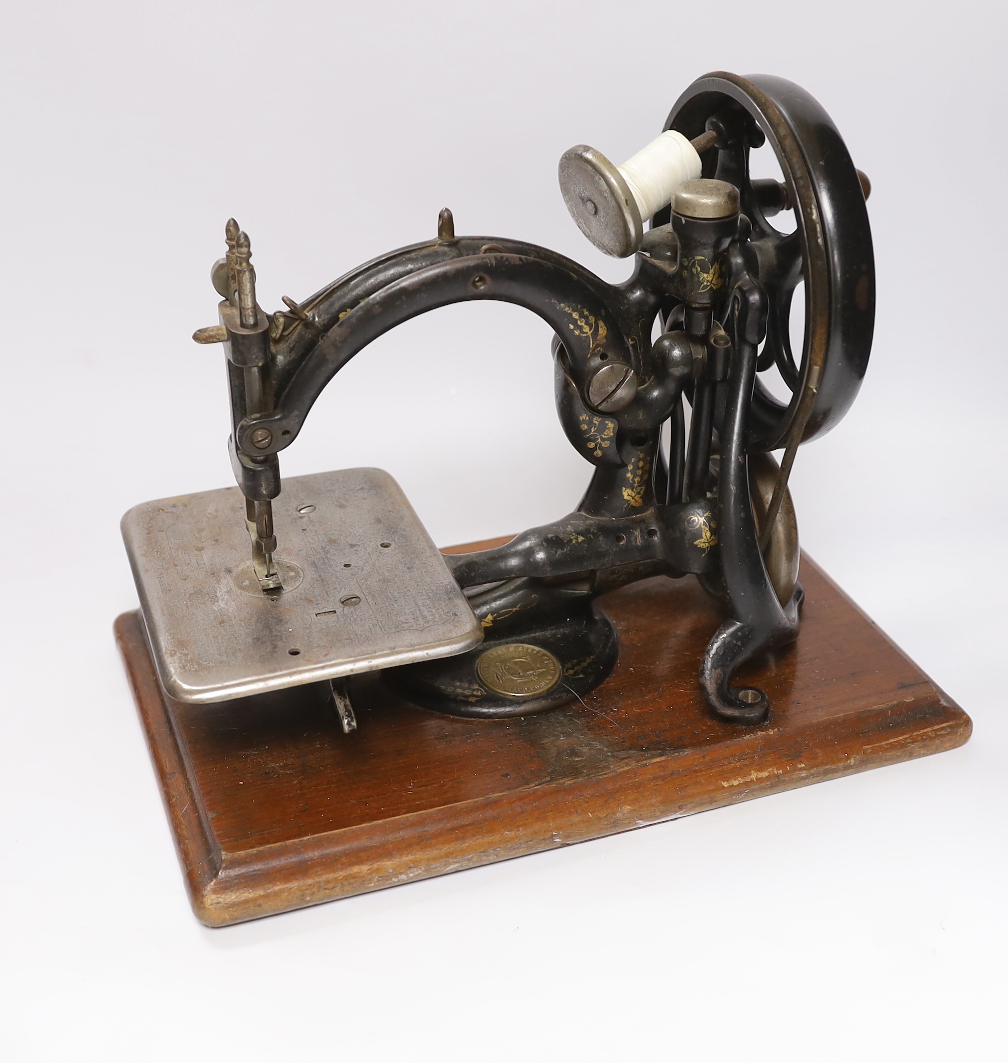 A Victorian Wilcox ad Gibbs sewing machine and a smaller sewing machine, 28cm high